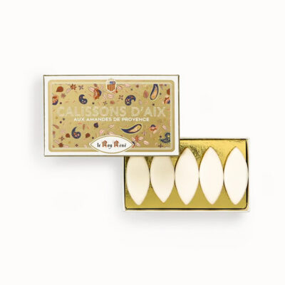 Gold box of Calissons d'Aix (almond confections) with four white almond-shaped candies in a gold tray; labeled Le Roy René, Provence–style.
