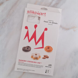 Box of Silikomart Danish Cookies XS set with red silhouettes and cookie molds on the front cover, showing designer branding and sample cookies.