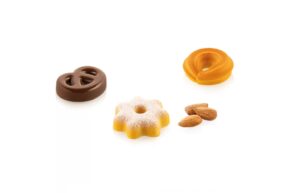 Assorted cookies and almonds on a white background, including a chocolate ring, an orange ring, and a powdered-sugar star-shaped cookie with a few almonds nearby
